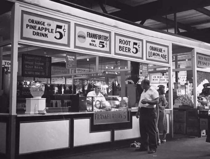 Customer standing in front of a food vendor, Coney Island, New York City, New York State, USA