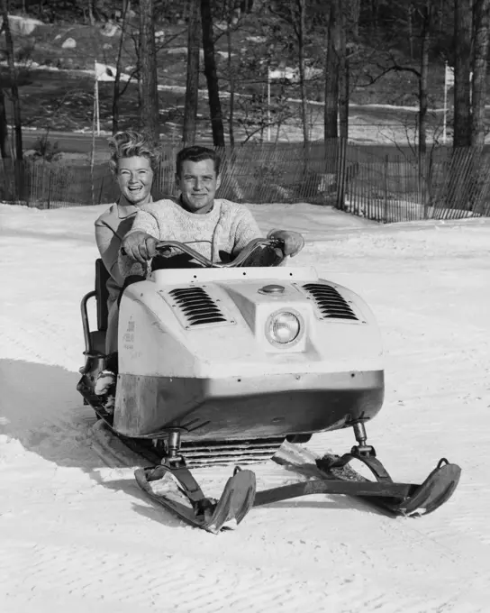 Mid adult couple snowmobiling