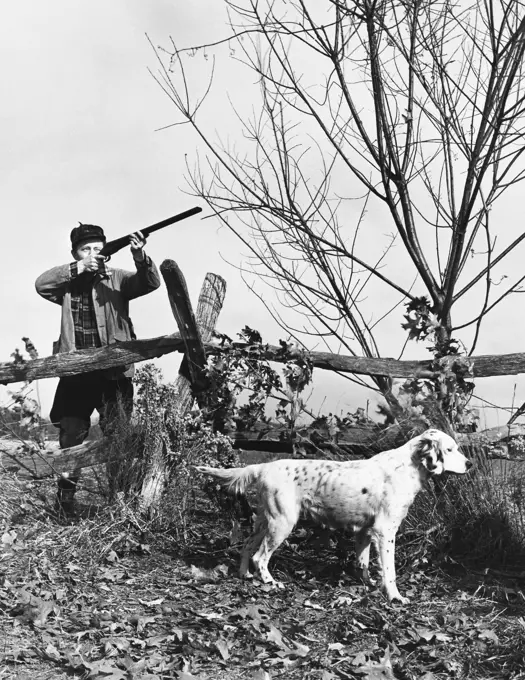 Male hunter aiming a rifle