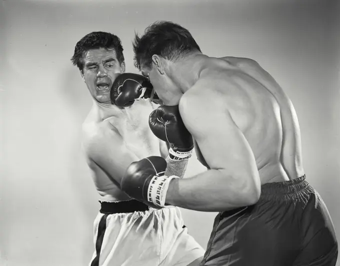 Vintage Photograph. Boxers wearing gloves in brawl. Frame 1