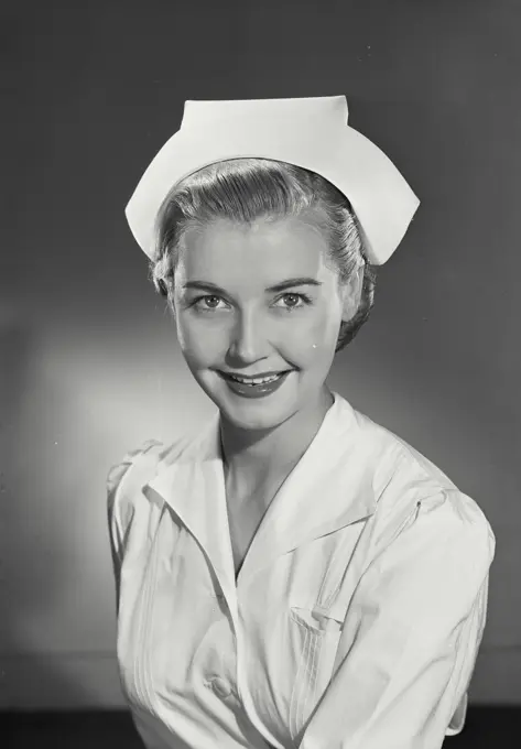 Vintage Photograph. Woman in nurses uniform smiling at camera