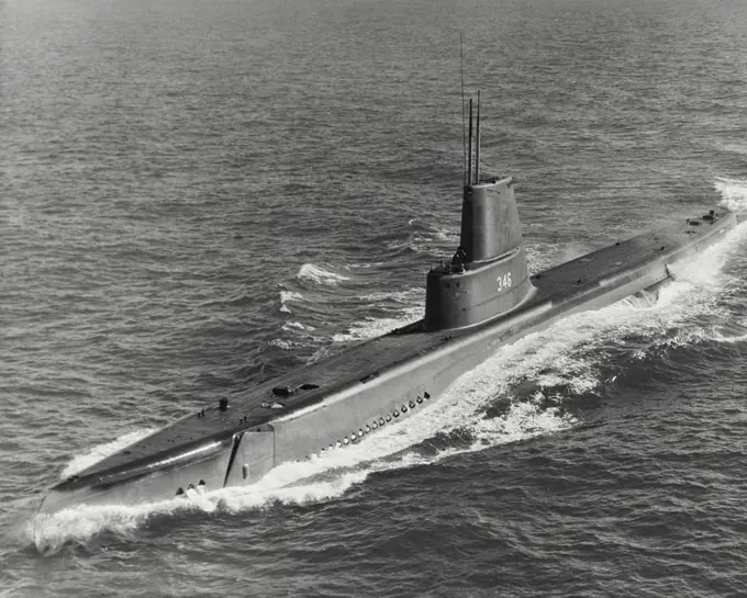 Vintage photograph. High angle view of submarine USS Corporal (SS-346) following streamlining to increase underwater speed