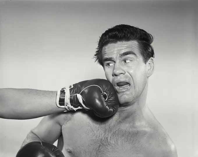 Vintage Photograph. Boxer being punched in face. Frame 1