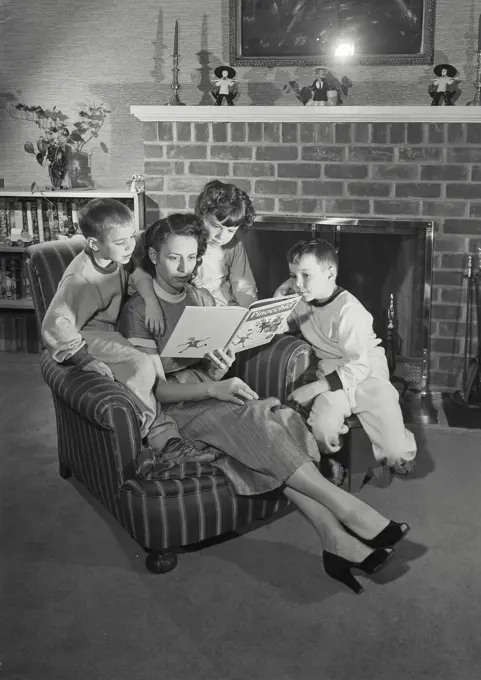 Vintage Photograph. Mother reading to her children in living room. Frame 3