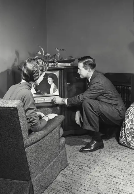Vintage Photograph. Couple in living room watching television. Frame 2