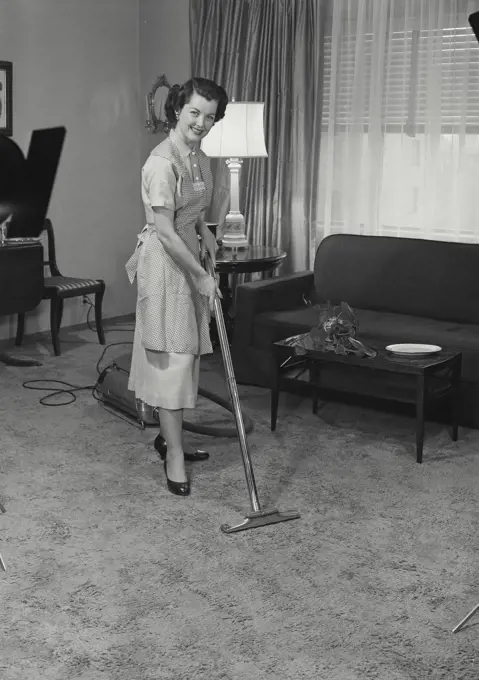 Vintage Photograph. Nellie Jane Cannon. Model Released. Woman vacuuming the living room. Frame 3