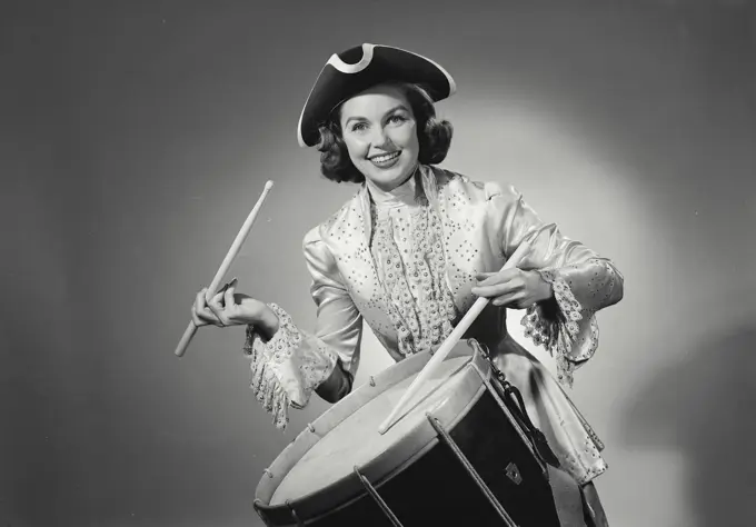 Vintage Photograph. Woman in long gown playing the drum. Frame 5