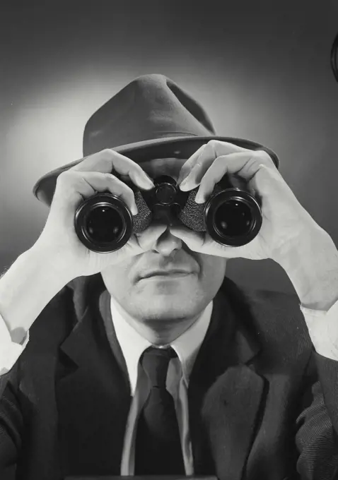 Vintage Photograph. Man wearing hat and looking through binoculars. Frame 2