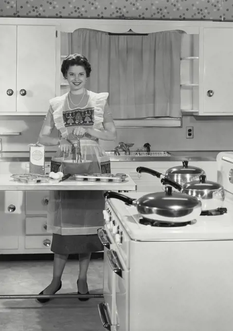 Vintage Photograph. Young matron seen preparing dinner. Frame 5