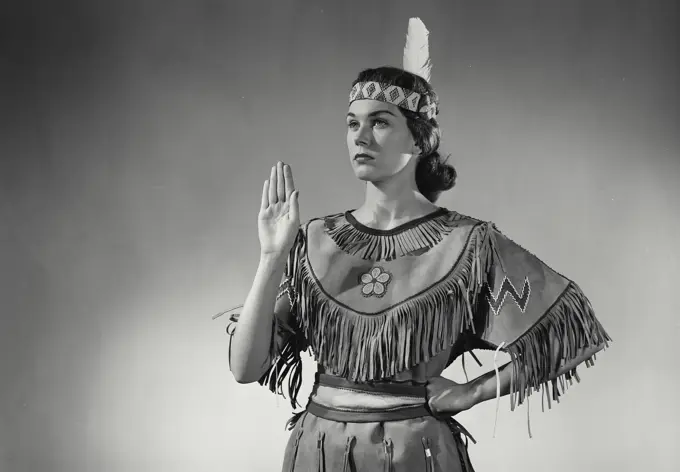 Vintage Photograph. Caucasian woman wearing Native American head dress. Frame 5