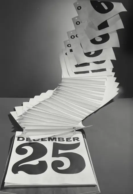 Vintage Photograph. Pages on daily calendar flipping up to reveal December 25th date, Christmas, Frame 2