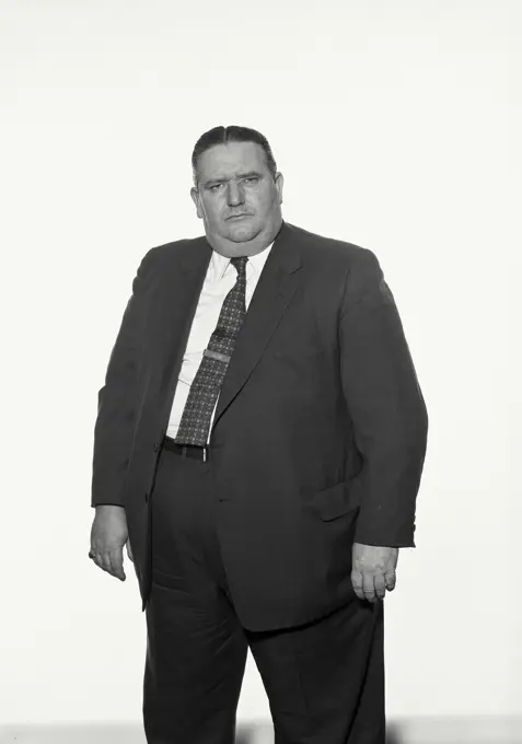 Vintage Photograph. Fat man wearing suit and tie frowning