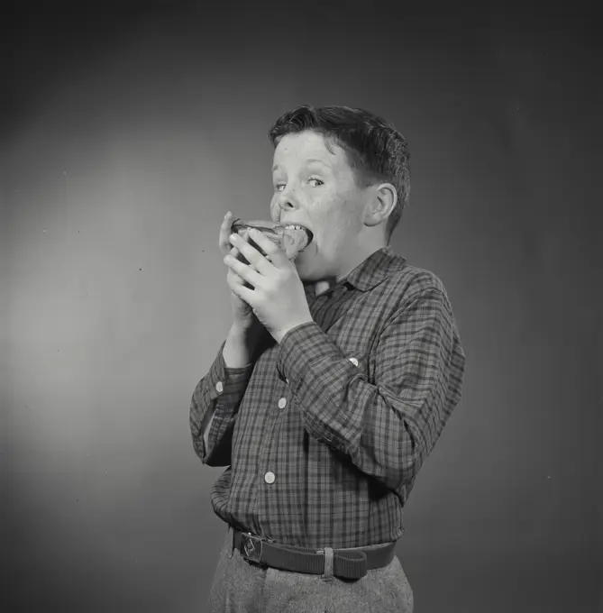 Vintage Photograph. Boy eating slice of pie with hands. Frame 4