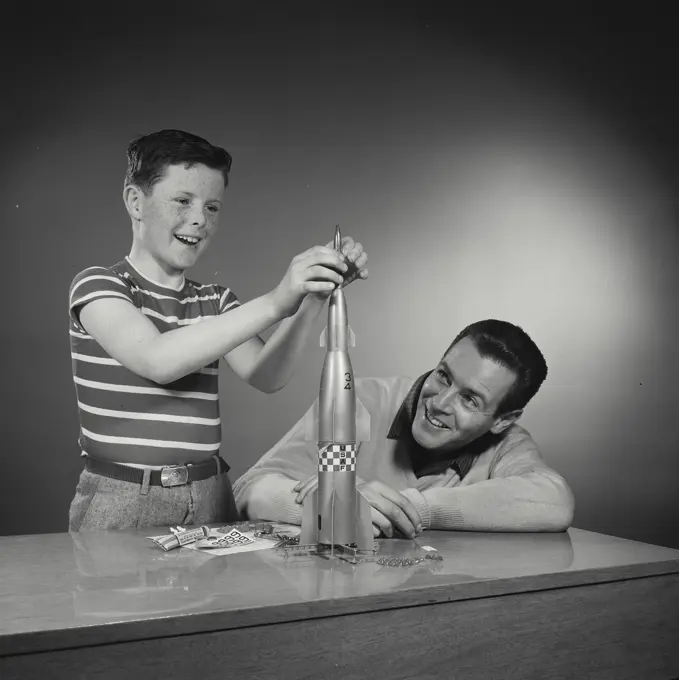 Vintage Photograph. Bill Baylan. Mel Jordan. Model Released. Father and son building model rocket. Frame 6