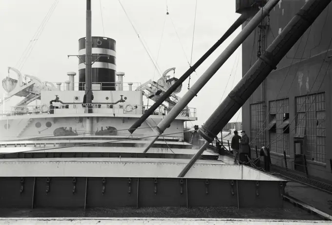 Vintage Photograph. Loading grain on grain boats at Port Arthur