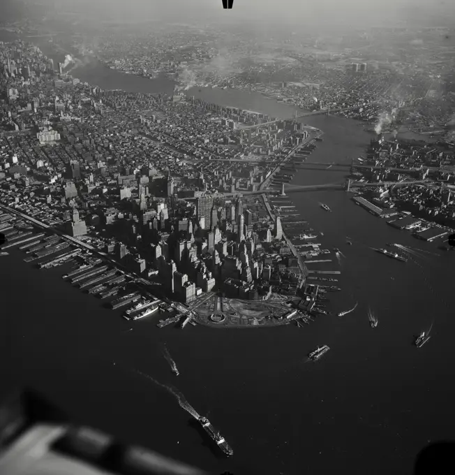 Vintage Photograph. Aerial view of Lower Manhattan skyscrapers and ships in the East River, looking North, New York City