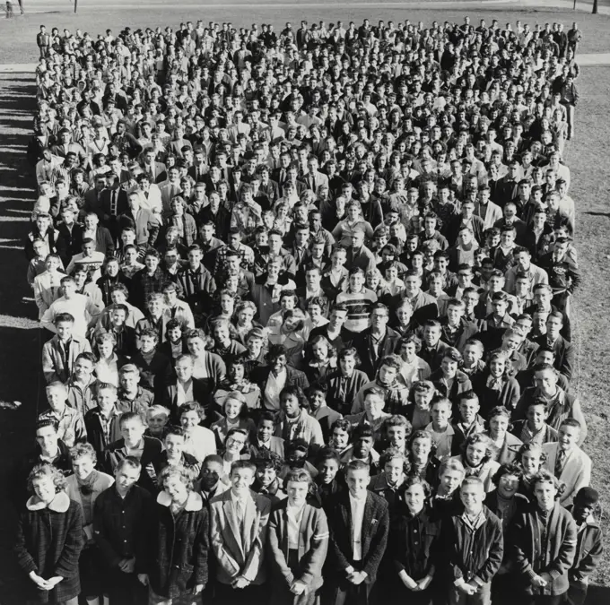 Vintage Photograph. Crowd of teenagers looking up at camera.