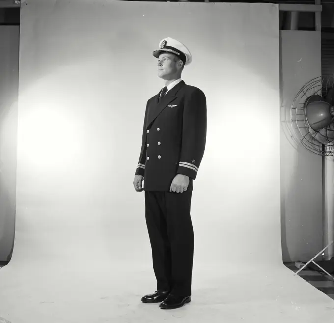 Vintage Photograph. Soldier in full dress stands at attention in studio portrait.