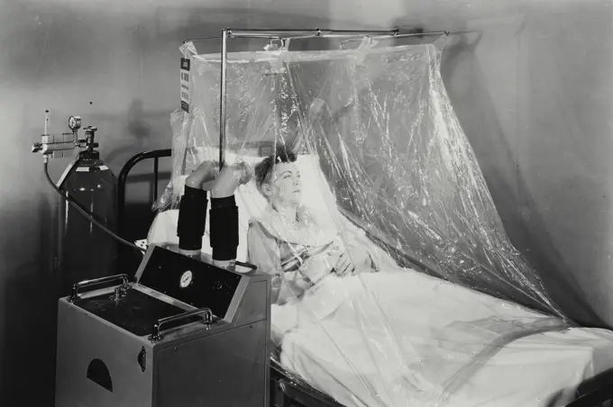 Vintage Photograph. Woman patient in an oxygen tent.