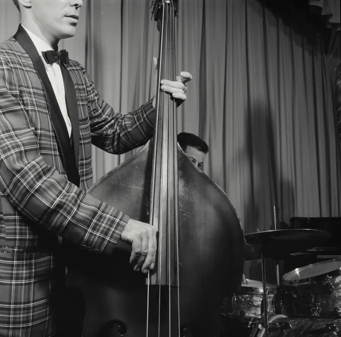 Vintage Photograph. Closeup of man playing bass.