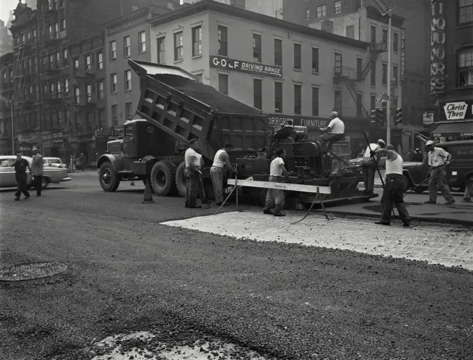 Vintage Photograph. Male workers spreading asphalt on resurfacing of Third Avenue, New York City