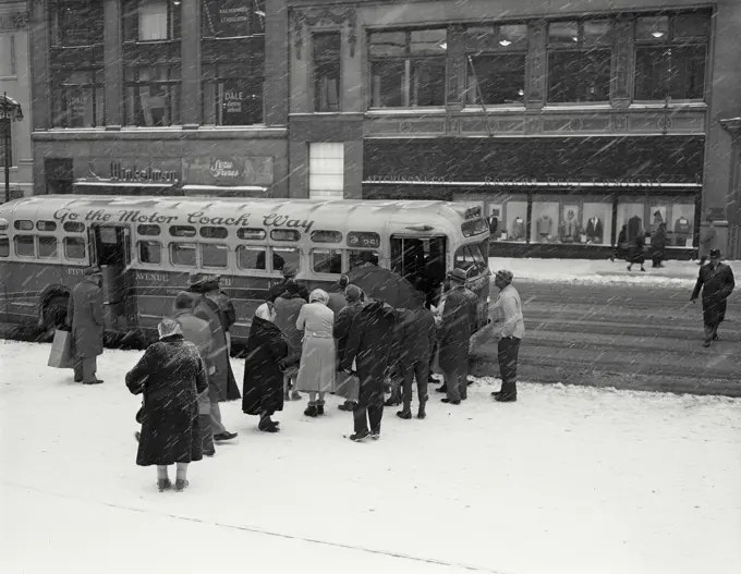 Vintage Photograph. People boarding bus on Fifth Avenue during snowstorm, New York City