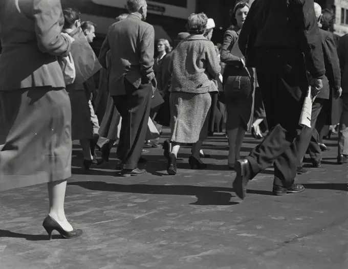 Vintage Photograph. Legs of pedestrians walking on sidewalk, Frame 3