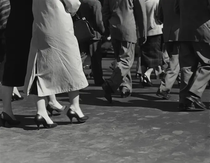 Vintage Photograph. Legs of pedestrians walking on sidewalk, Frame 4