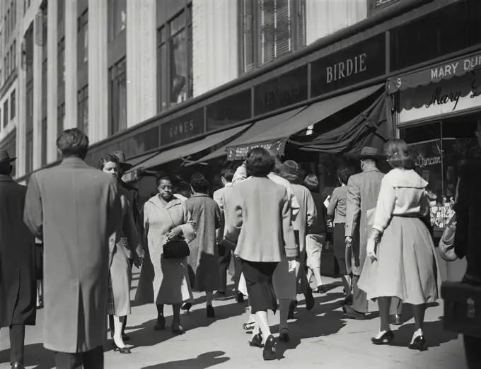 Vintage Photograph. Pedestrians walking on sidewalk near shops, New York City