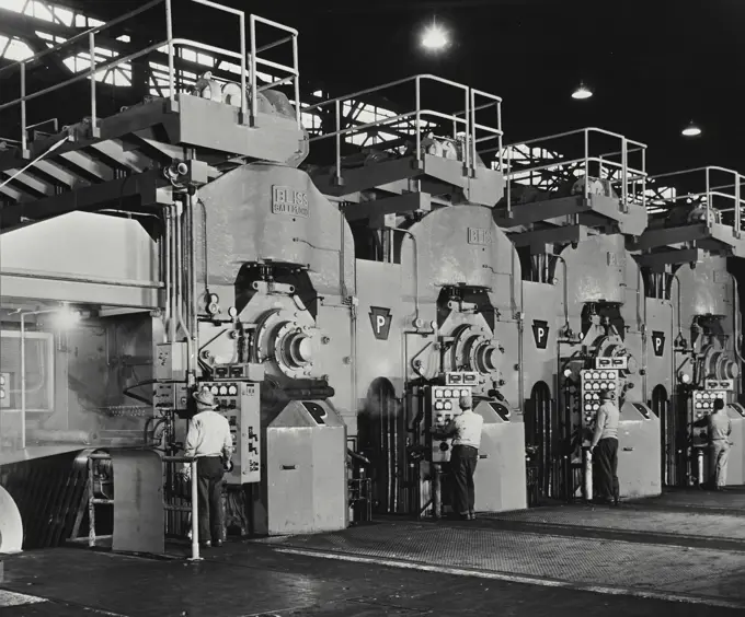 Vintage Photograph. Cold rolled steel sheets roll through for stand tandem mill.