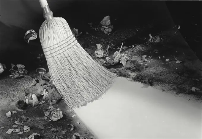 Vintage Photograph. Broom sweeps very dirty floor. Frame 6.