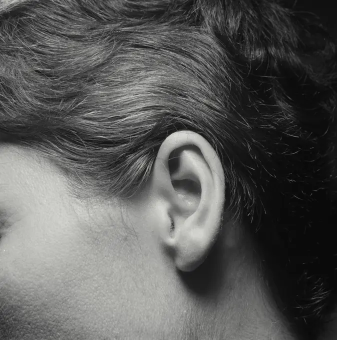 Vintage Photograph. Closeup of woman's ear.