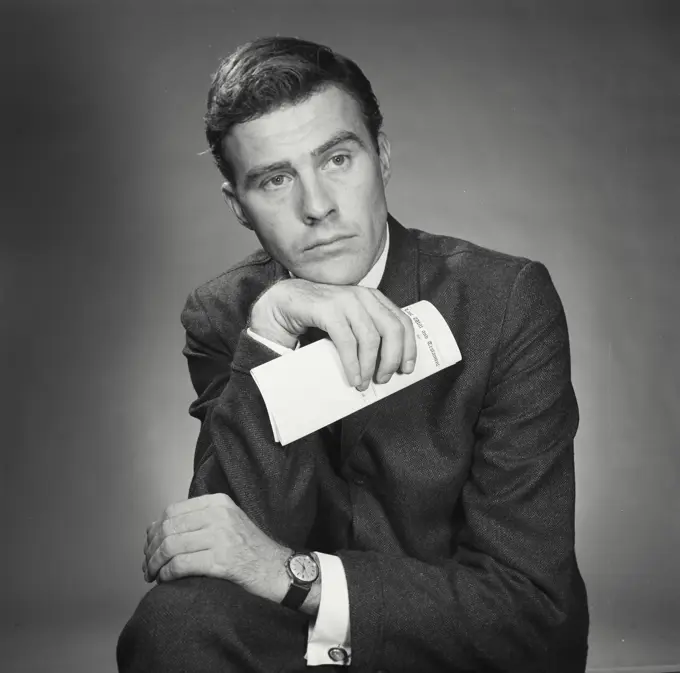 Vintage Photograph. Portrait of man in business attire with document. Frame 1