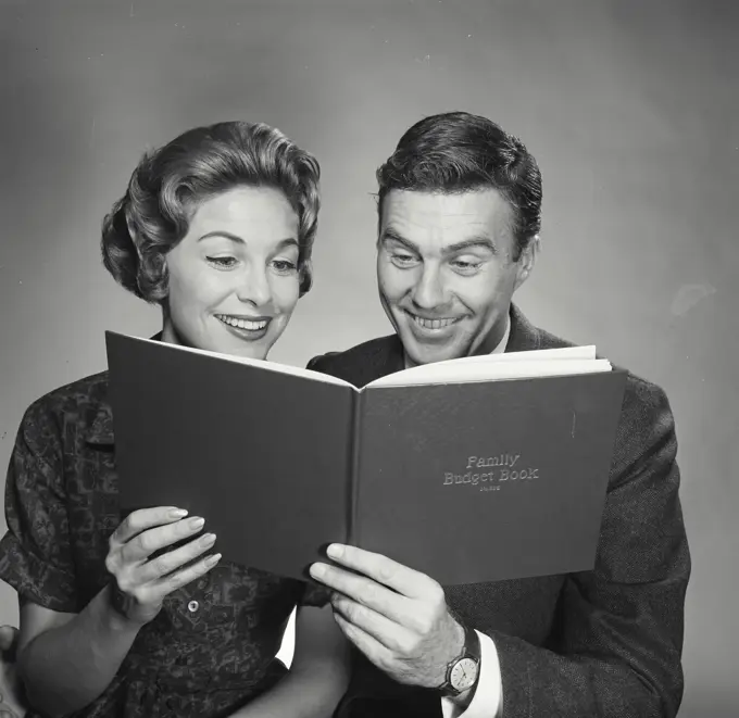 Vintage Photograph. Husband and wife going over the family budget. Frame 1