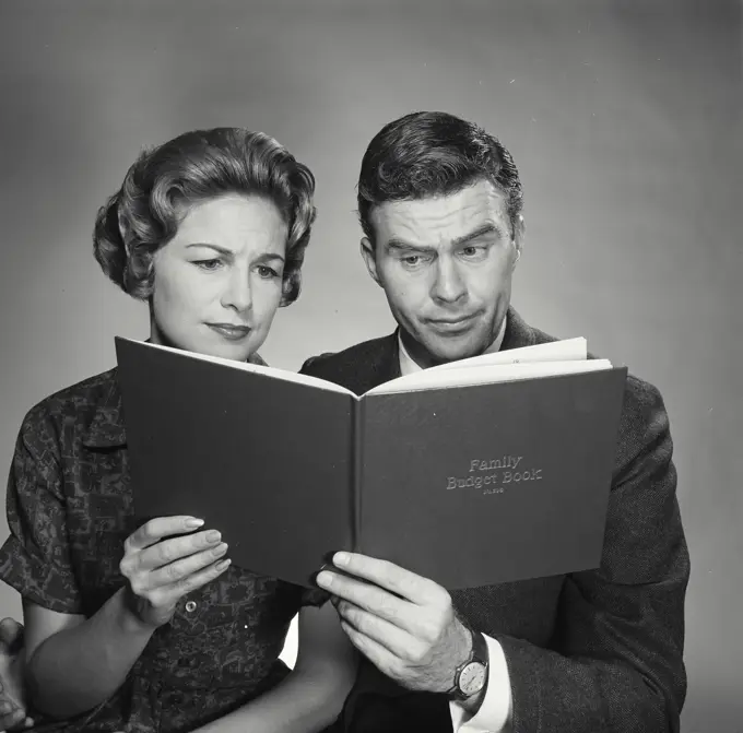 Vintage Photograph. Husband and wife going over the family budget. Frame 3