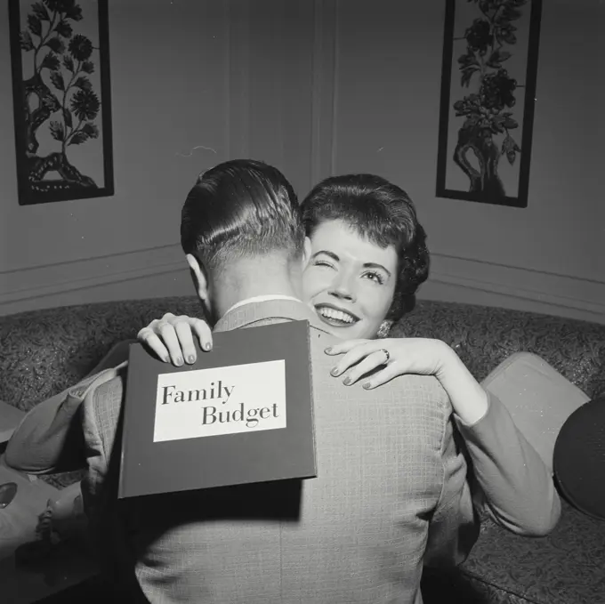 Vintage Photograph. Woman hugging husband and holding family budget. Frame 4