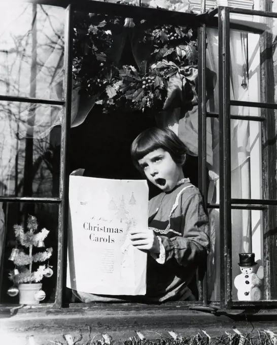 Girl sitting at the window and singing