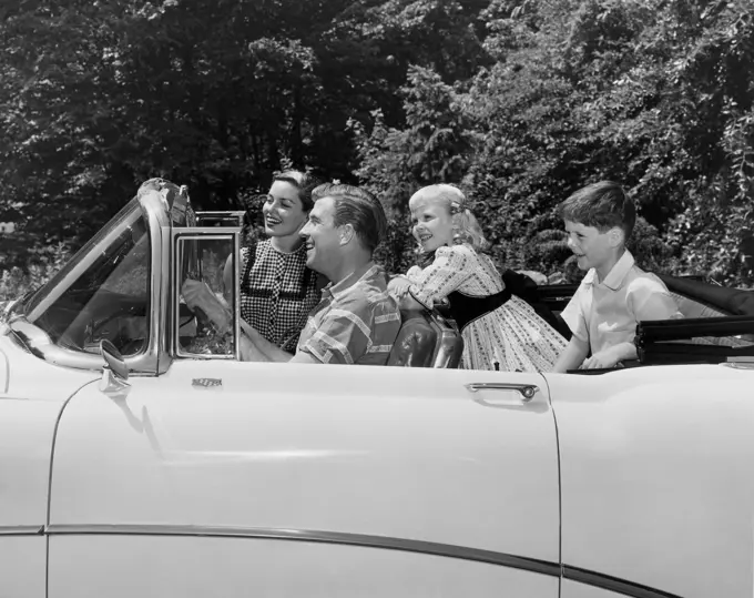 Parents and their children traveling in a car