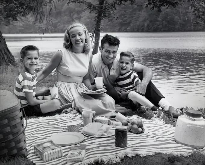 Portrait of a family at a picnic near a lake