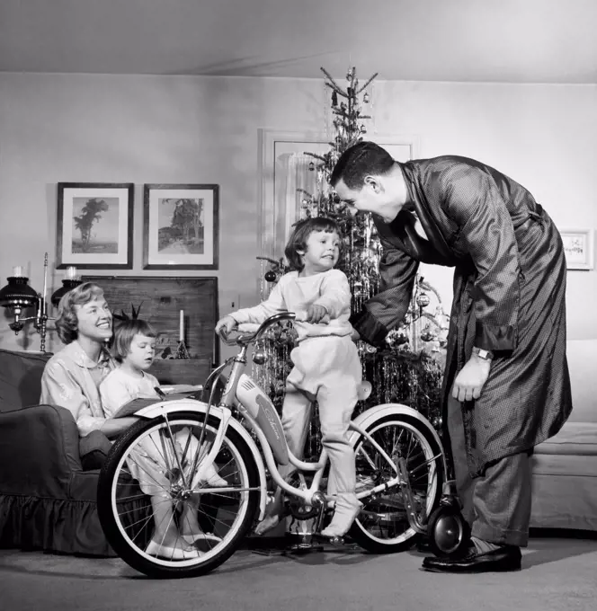 Parents with their son and daughter in a living room