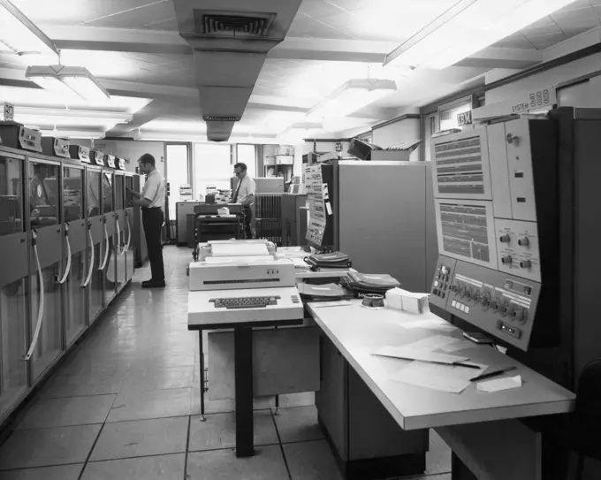 Side profile of two technicians working in a computer lab