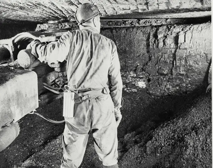 Vintage photograph. Rear view of a miner working in a coal mine, Pennsylvania, USA