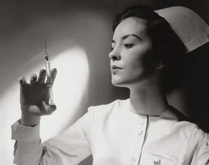 Close-up of a female nurse holding a syringe