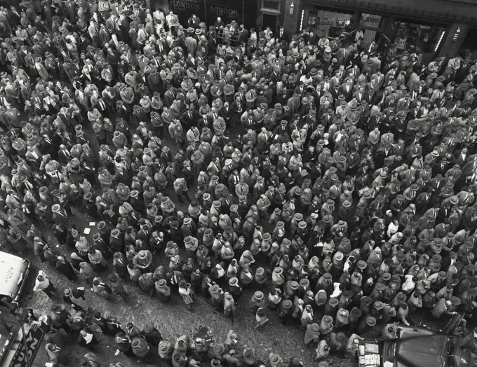 Vintage Photograph. Large crowd gathering around trucks. Frame 4