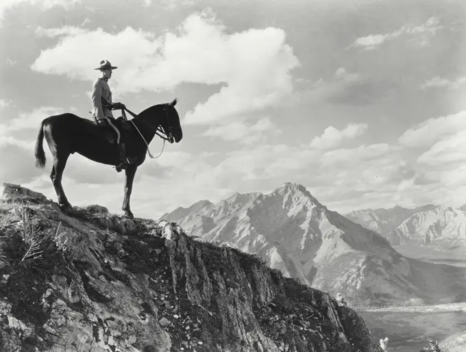 Vintage photograph. A Royal Canadian Mounted Police constable atop Sulphur Mountain in Banff National Park, Alberta, Canada