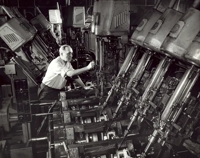 Side profile of a male working in a factory, Crankshaft Oil System Drill, Ford Motor Company, Dearborn, Michigan, USA