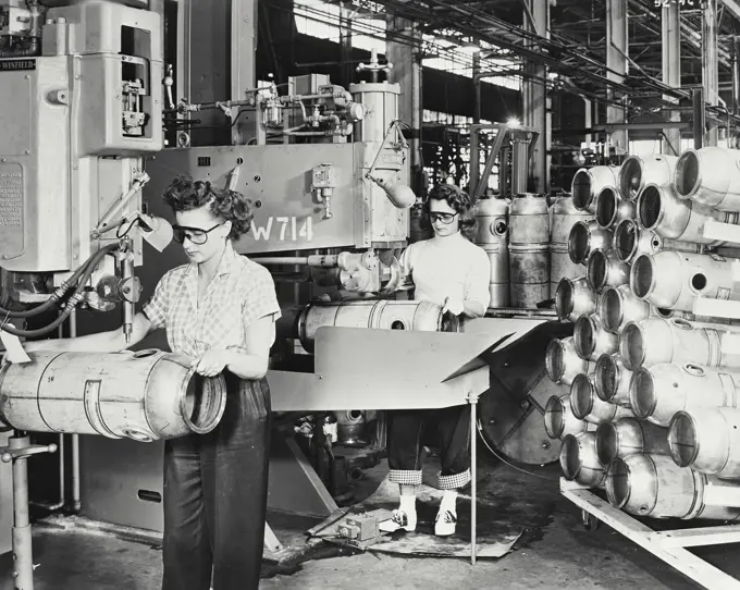 Vintage photograph. Two female workers welding combustion chambers of J47 Jet Engines with spot welding and seam welding in a factory