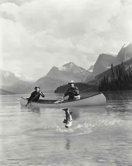 Vintage Photograph. Two men fishing in a lake, Maligne Lake, Jasper National Park, Alberta, Canada