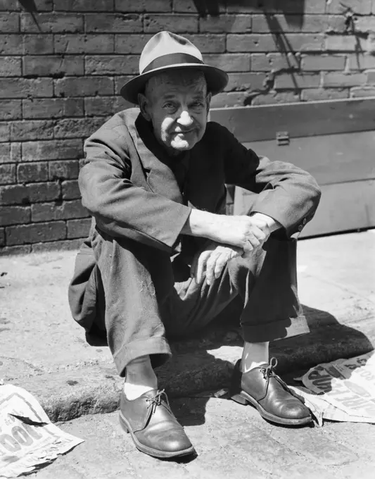 Portrait of a mature man sitting on the street