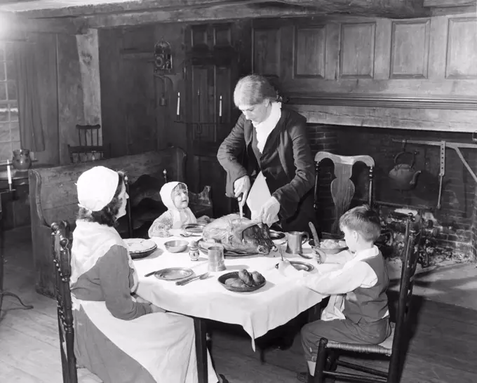 Family at a dining table on Thanksgiving Day, Old Sturbridge Village, Sturbridge, Massachusetts, USA